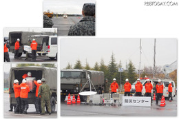 シーン2「可搬型基地局の出動訓練」。途中で陸上自衛隊のトラックに機材を積み替える。防災センターに到着すると、基地局が構築された